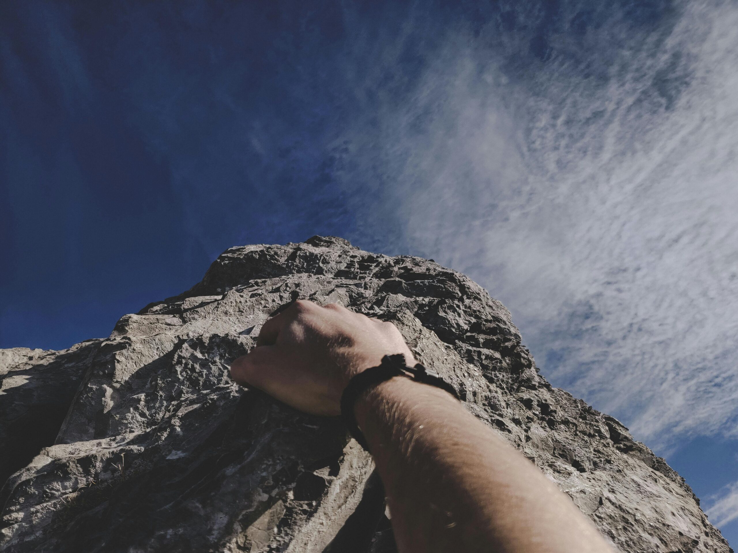 Person learning how to stop beating yourself up while climbing a mountain