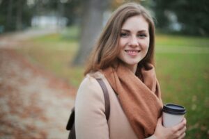 Woman holding a coffee on her way to couples counseling for one