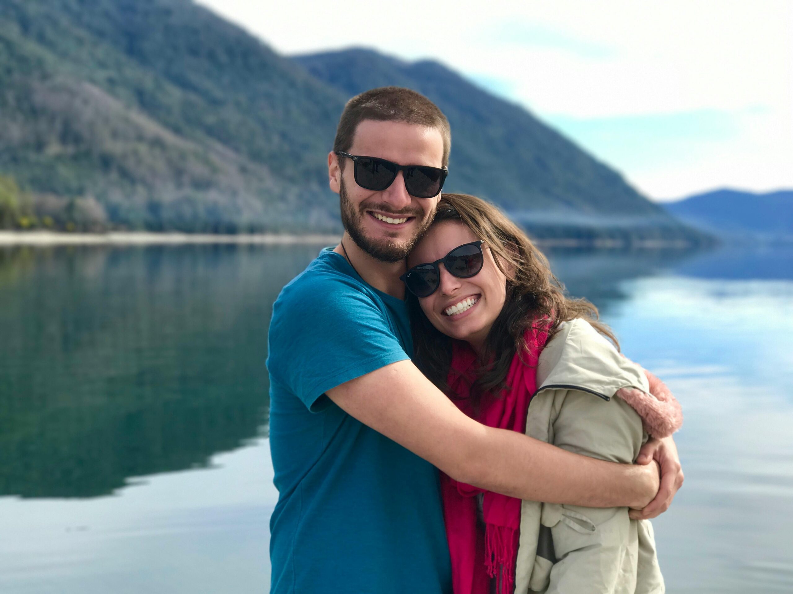 First time couple on a date hugging each other by a lake