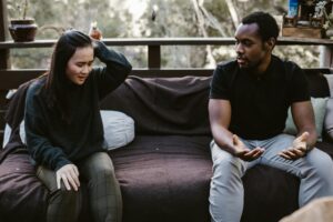 a woman struggling while talking to a man who is gaslighting her