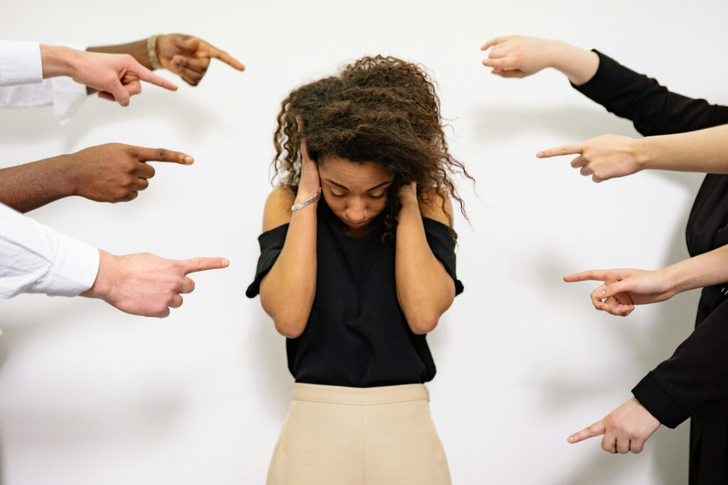 woman being criticized by others