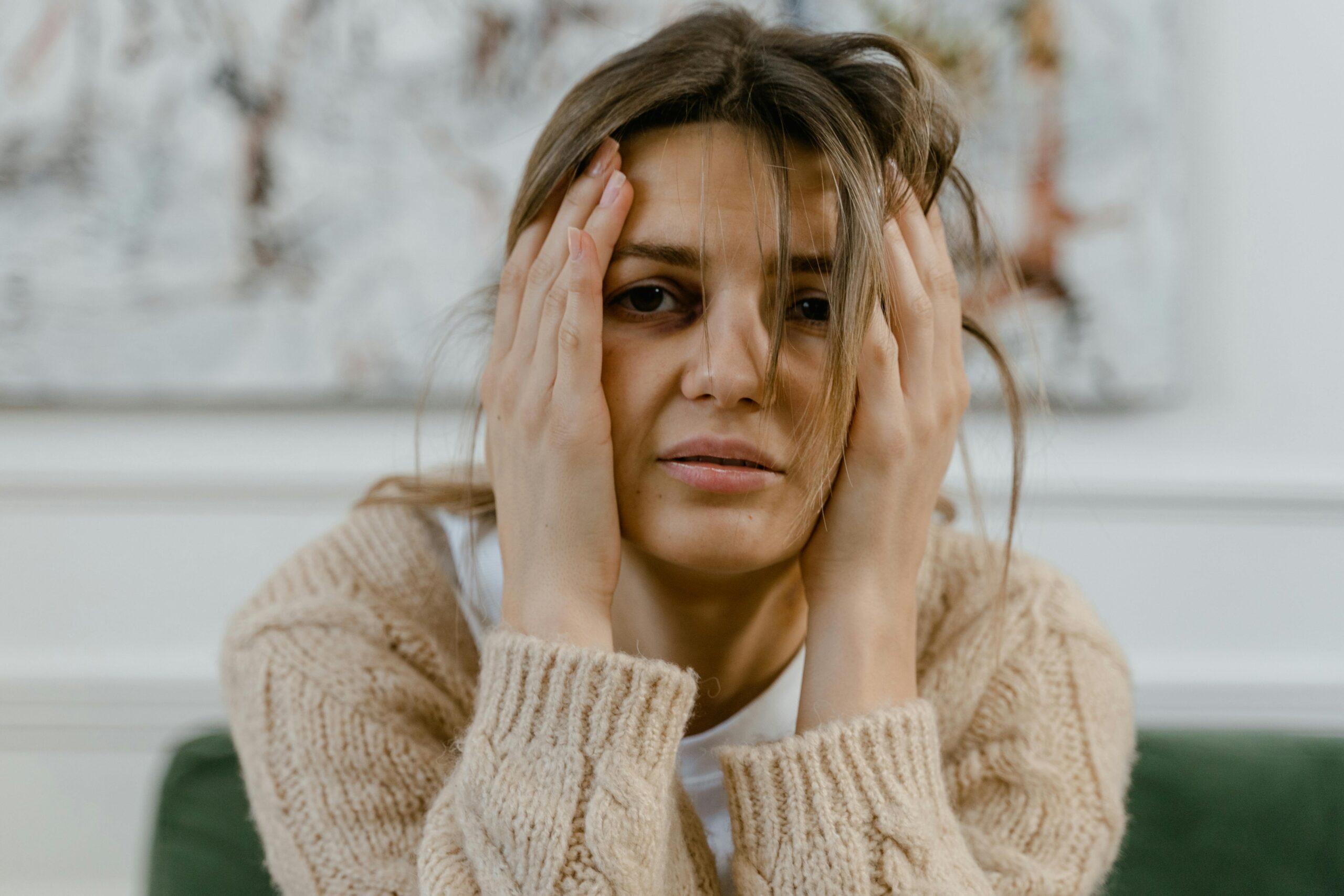 Stressed woman holding her head in her hands